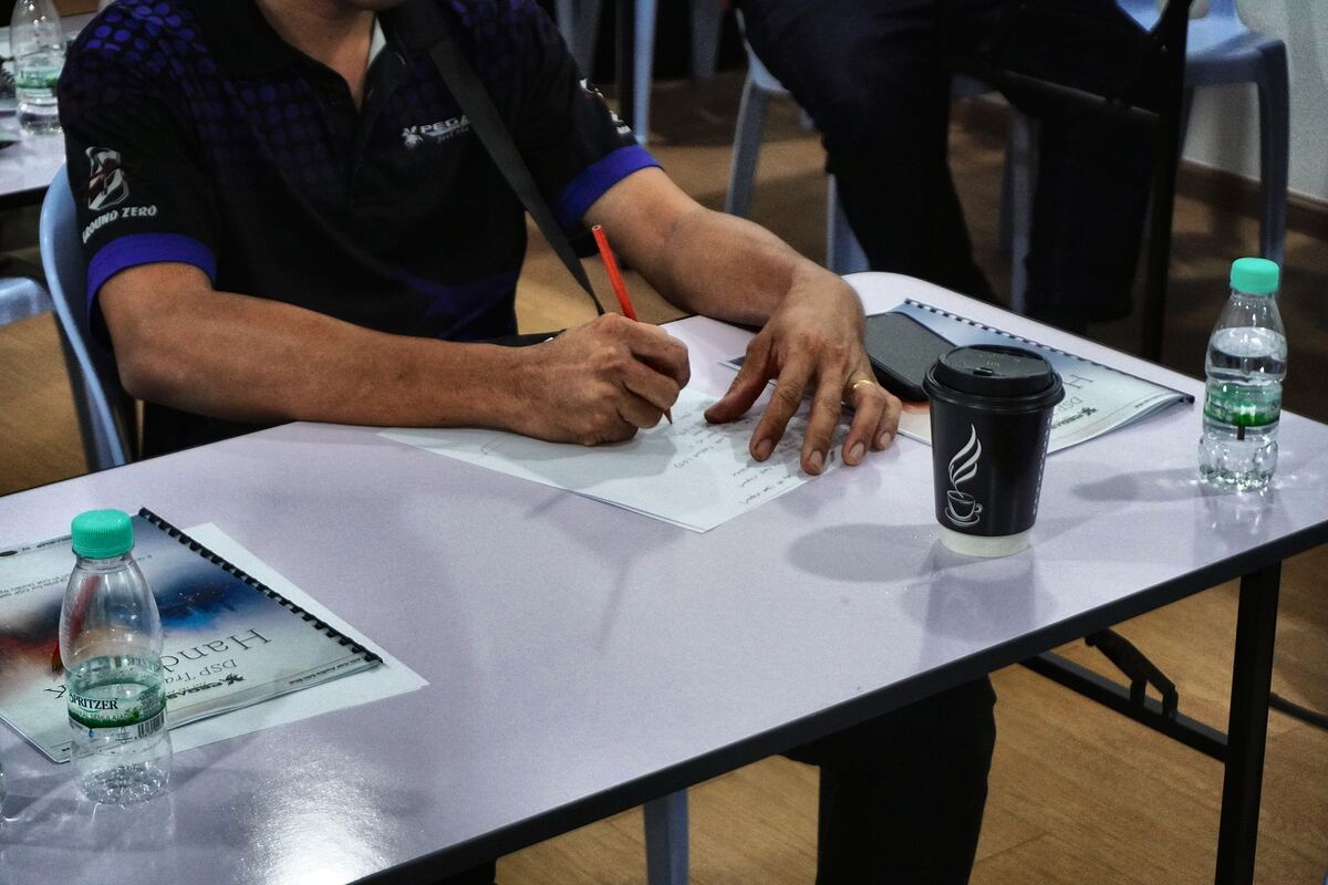 An attendee writing notes in the DSP Tuning Handbook during the classroom session.